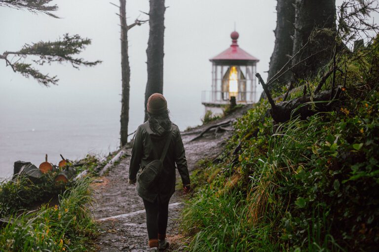 Fall hiking at the Oregon Coast: A woman wears rain gear as an example of what to wear in fall at the Oregon Coast