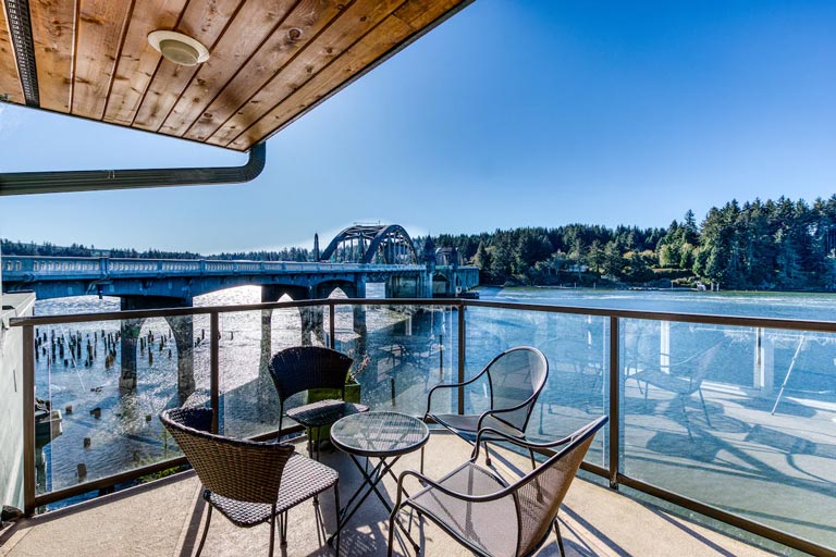 Riverfront vacation rental with a balcony and bridge view in Florence, Oregon