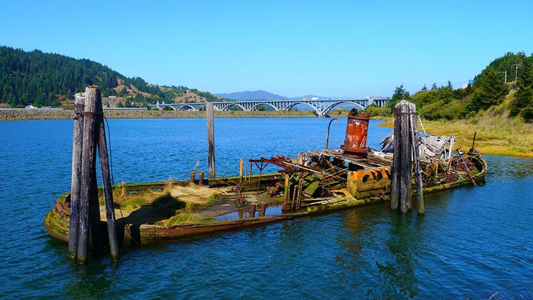 The shipwreck of the Mary D. Hume sinks slowly in the Rogue River in Gold Beach, Oregon