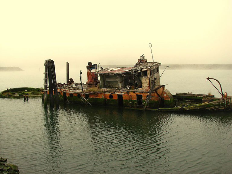 The wreck of the Mary D. Hume sinks slowly in the Rogue River in Gold Beach, Oregon