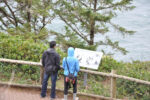 A couple wearing rain jackets at Cape Meares at the Oregon Coast