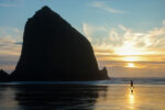 Haystack rock silhouetted on Cannon Beach, Oregon at sunset