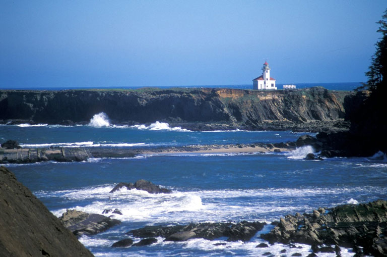 Cape Arago lighthouse sits on a rocky outcropping, as seen on a hike at the southern Oregon Coast near Coos Bay