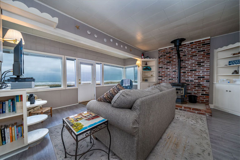Interior of a beachfront bungalow in Rockaway Beach with an oceanfront view and wood stove