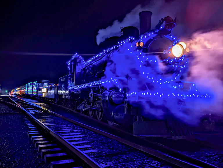 The Candy Cane Express steam train is lit up for Christmas on the Oregon Coast Scenic Railroad in Garibaldi