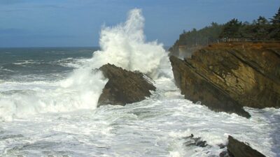 Huge King Tide waves crash against the rocks at Shore Acres State Park near Coos Bay, Oregon