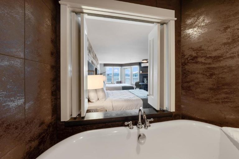 Suites at Cannery Pier Hotel and Spa in Astoria, Oregon feature clawfoot deep soaking tubs with a view of the river