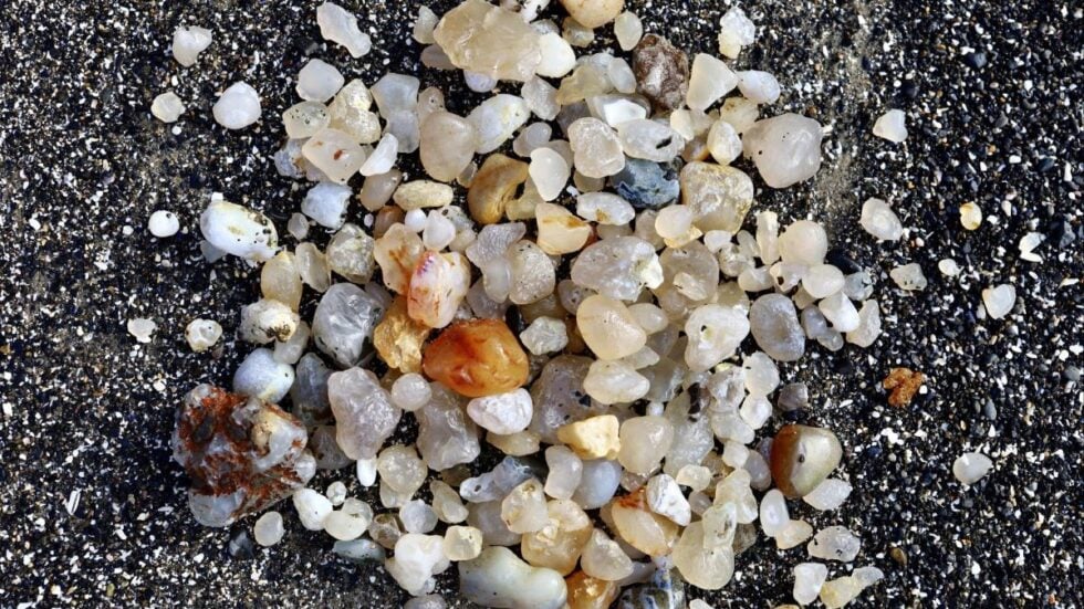 A pile of agates on the beach found while rockhounding on the Oregon Coast