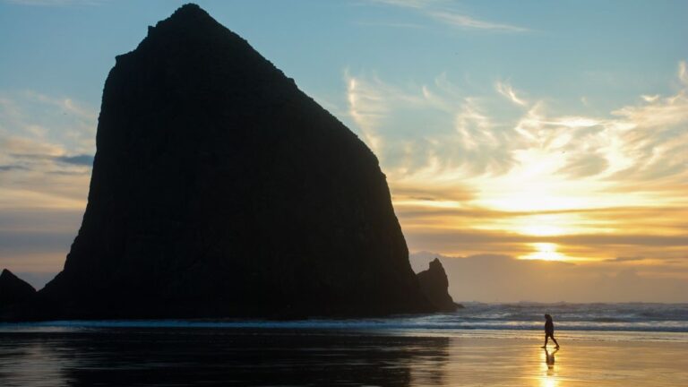 Haystack rock silhouetted on Cannon Beach, Oregon at sunset on the Oregon Coast
