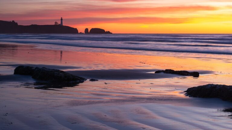 Agate Beach in Newport Oregon with a view of Yaquina Bay Lighthouse at sunset on the Oregon Coast