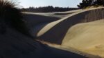 Sand dunes form shadows in the Oregon Dunes National Recreation Area near Florence, Oregon