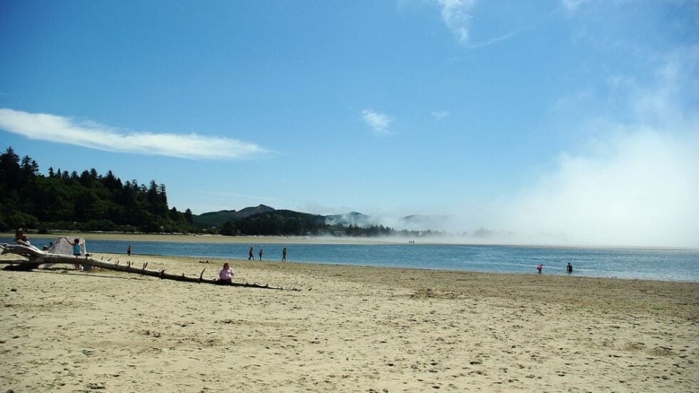 The beach on calm and shallow Siletz Bay, one of the top things to do in Lincoln City, Oregon