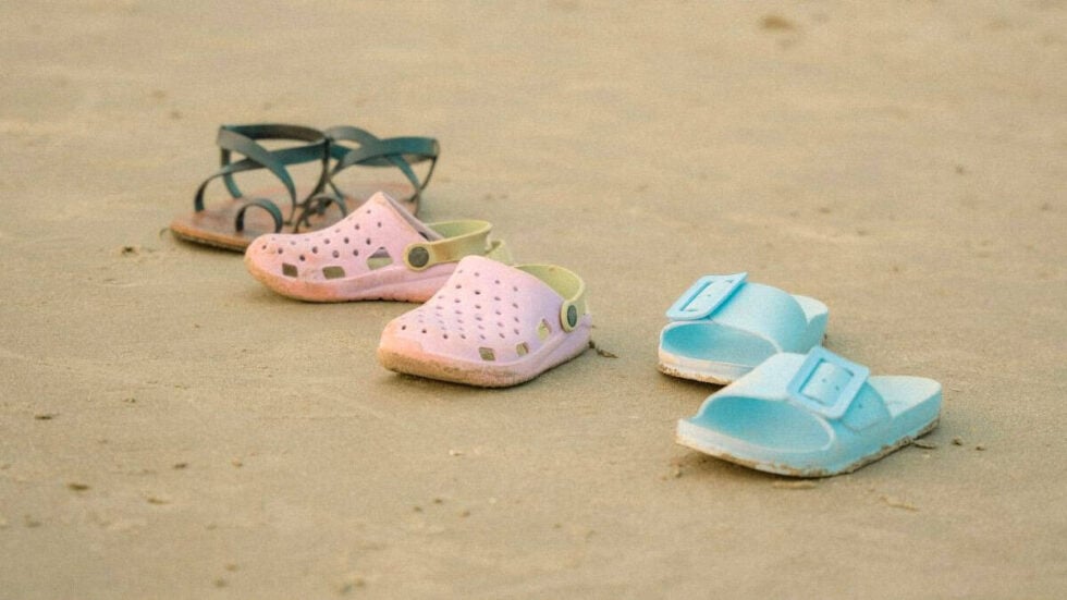 Casual and comfortable summer travel walking sandals on the beach.